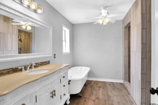 bathroom featuring separate shower and tub, decorative backsplash, hardwood / wood-style floors, and vanity