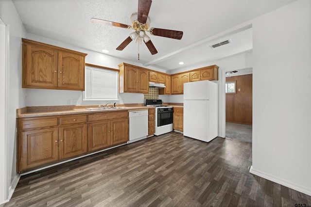 kitchen featuring white appliances, sink, ceiling fan, a textured ceiling, and dark hardwood / wood-style flooring