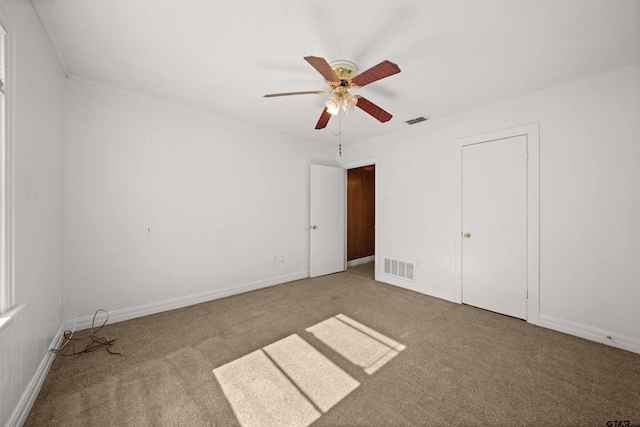 unfurnished bedroom with carpet floors and ceiling fan