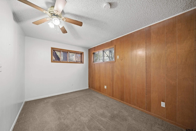 unfurnished room with ceiling fan, carpet, and a textured ceiling