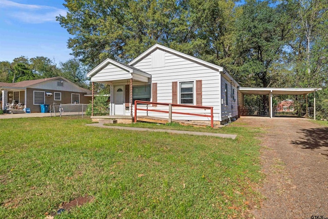 view of front of house with a carport, a porch, and a front lawn