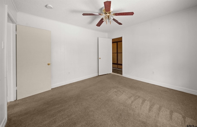 spare room featuring carpet, ceiling fan, and a textured ceiling