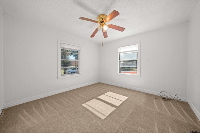 carpeted empty room with a textured ceiling and ceiling fan