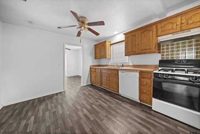 kitchen featuring a textured ceiling, dark wood-type flooring, sink, dishwasher, and range