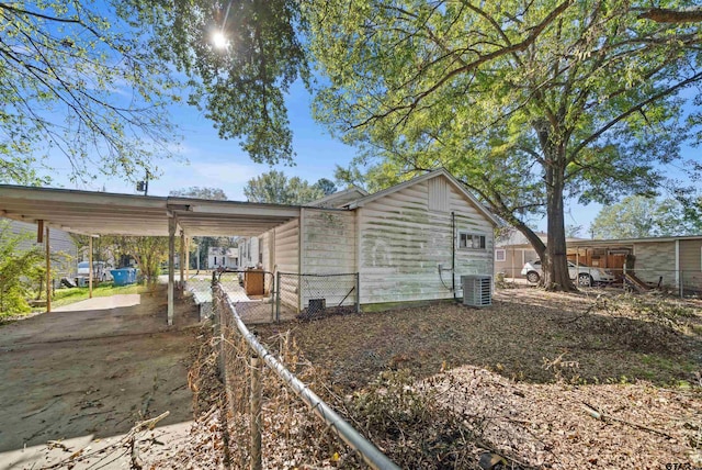 view of home's exterior with central AC unit and a carport