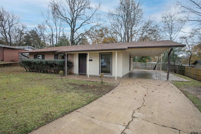 view of front of home with a front lawn and a carport