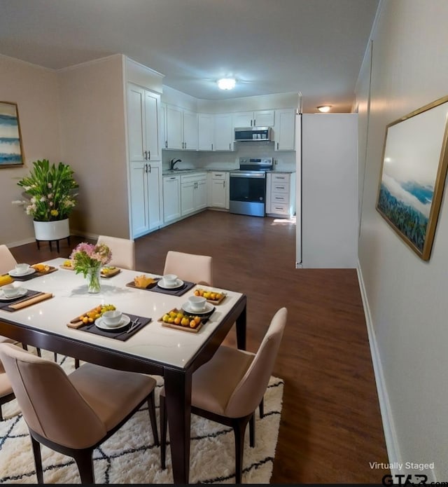 dining room with dark hardwood / wood-style flooring and sink