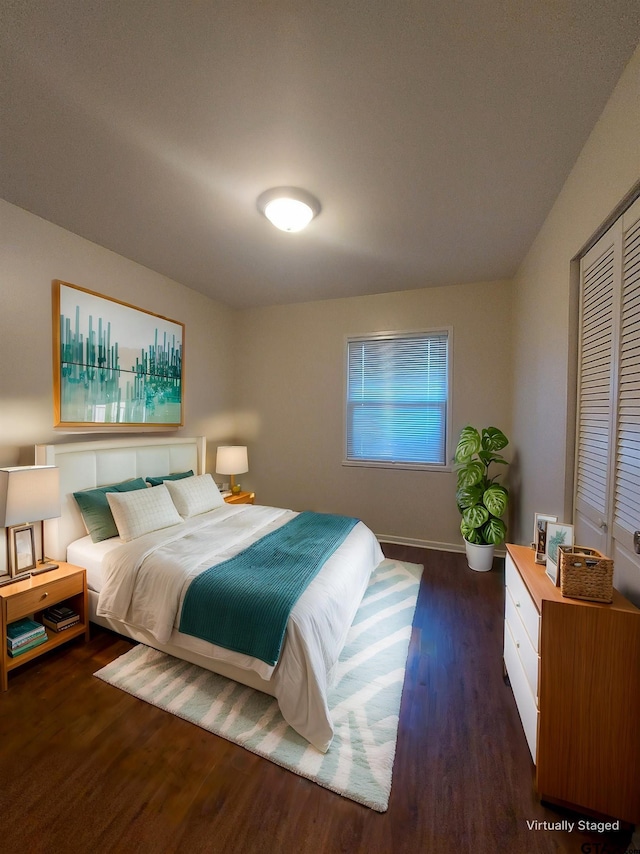 bedroom with a closet and dark hardwood / wood-style flooring