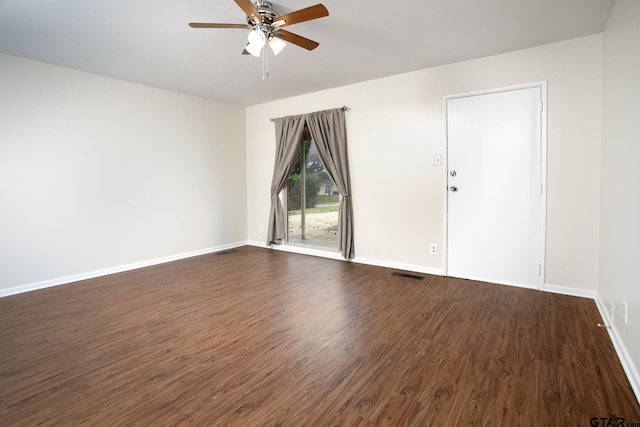 spare room with dark hardwood / wood-style flooring and ceiling fan