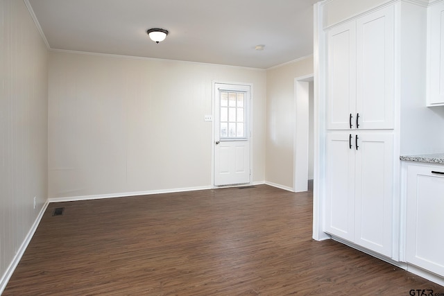 unfurnished room with dark hardwood / wood-style flooring and crown molding