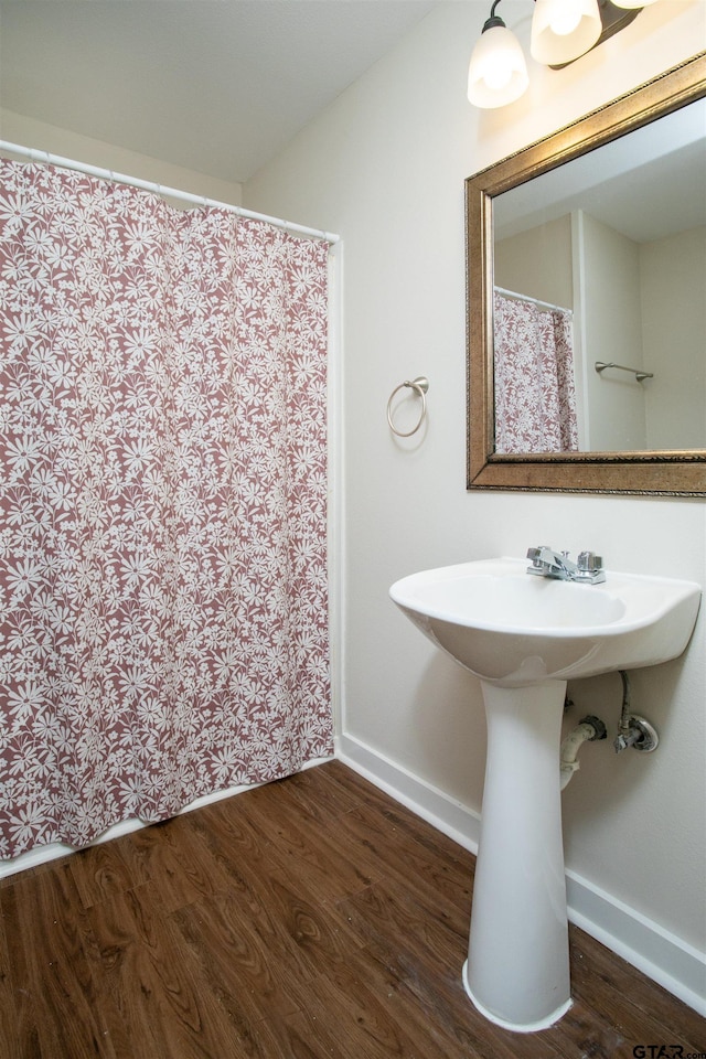 bathroom with hardwood / wood-style flooring