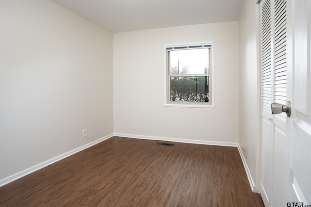 empty room featuring dark hardwood / wood-style floors