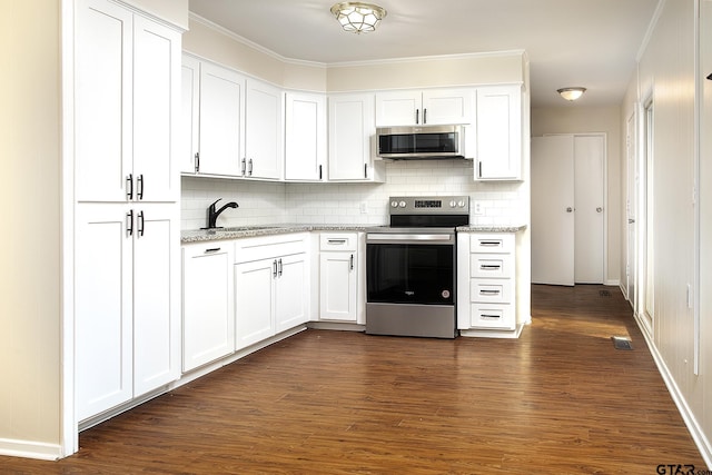 kitchen featuring sink, dark hardwood / wood-style flooring, light stone counters, white cabinetry, and stainless steel appliances