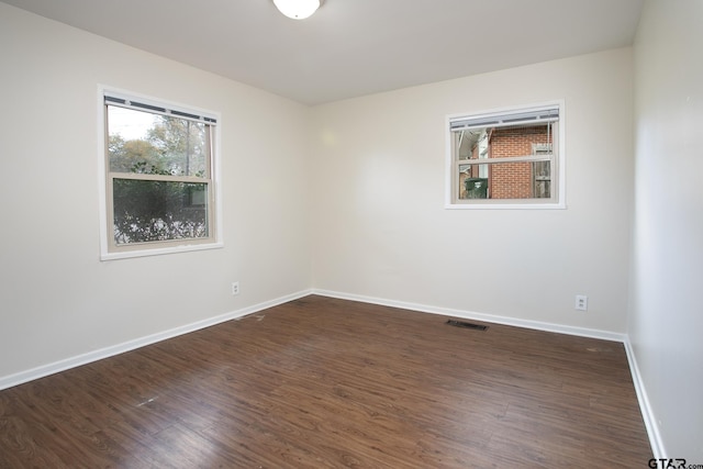 spare room featuring dark hardwood / wood-style flooring