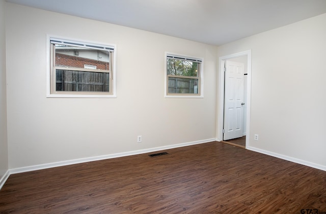 spare room with dark wood-type flooring