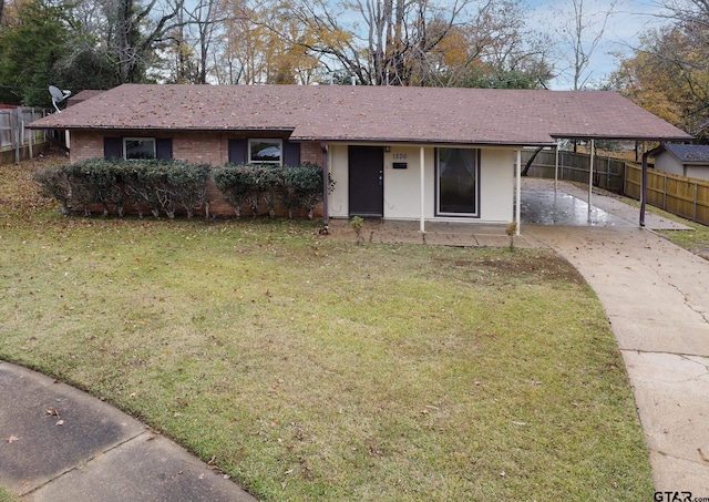 ranch-style house featuring a front lawn and a carport