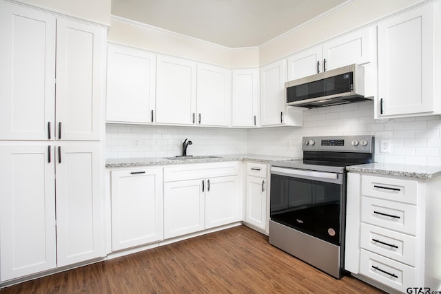 kitchen featuring dark hardwood / wood-style flooring, white cabinetry, sink, and stainless steel appliances