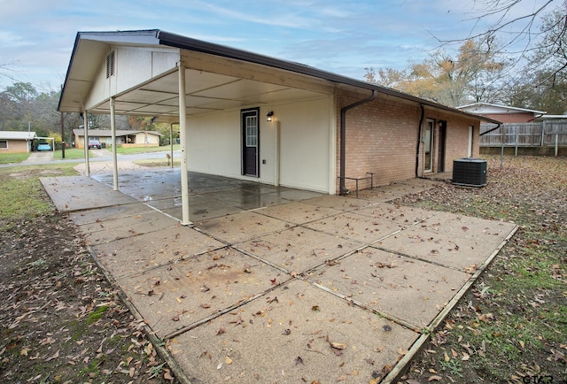 exterior space featuring central air condition unit and a patio