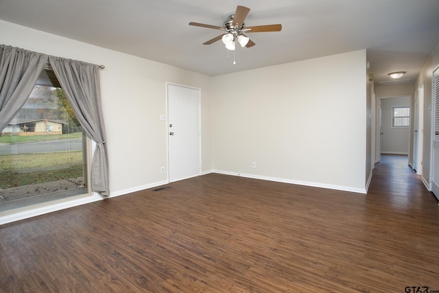 spare room featuring ceiling fan and dark hardwood / wood-style flooring