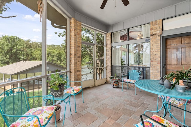 sunroom / solarium featuring ceiling fan