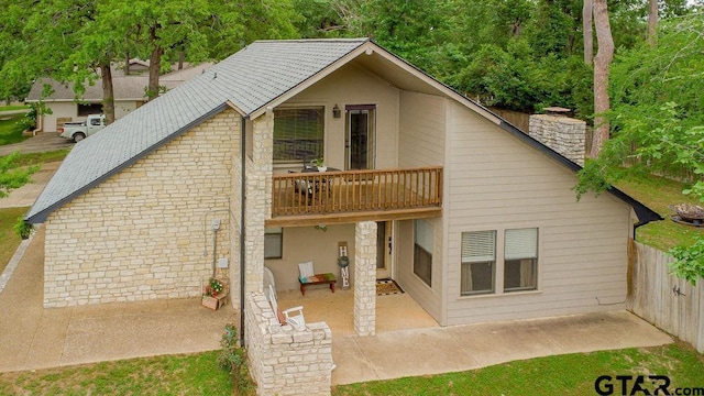 425 Lakeview Dr, Hideaway, TX 75771 - back of property with a balcony, a patio area, a chimney, and fence