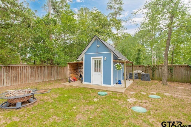 425 Lakeview Dr, Hideaway, TX 75771 - view of shed featuring an outdoor fire pit and view of wooded area
