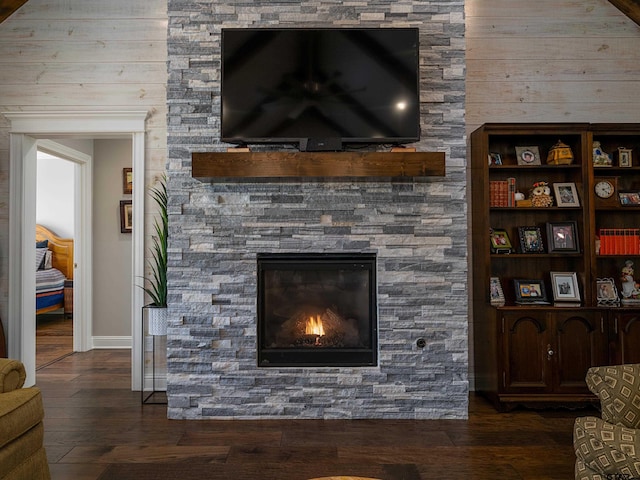 room details with a fireplace, baseboards, and wood finished floors