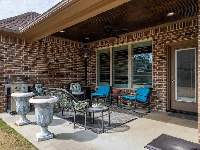 view of patio / terrace featuring an outdoor living space, area for grilling, and a ceiling fan