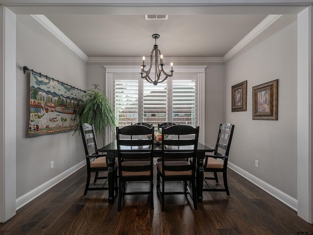 dining space with a notable chandelier, visible vents, ornamental molding, dark wood-type flooring, and baseboards