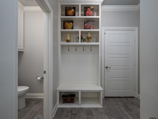 mudroom with crown molding, baseboards, and wood finished floors