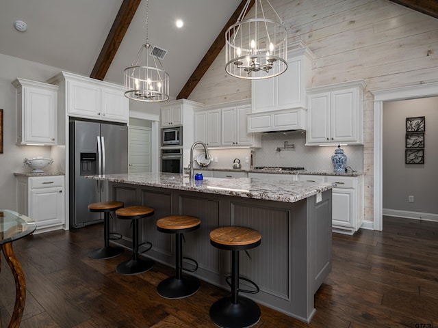 kitchen with stainless steel appliances, backsplash, dark wood finished floors, and a notable chandelier