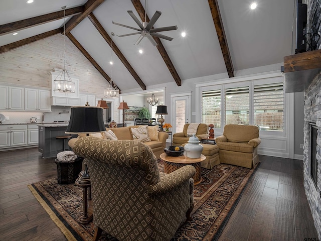 living room featuring high vaulted ceiling, a fireplace, dark wood finished floors, and beam ceiling