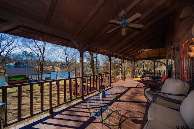 deck featuring a water view and ceiling fan