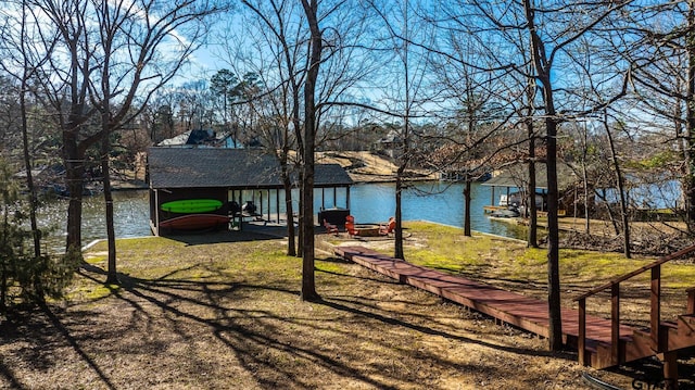 view of yard featuring a boat dock and a water view