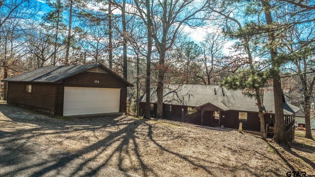 exterior space with a detached garage and an outdoor structure