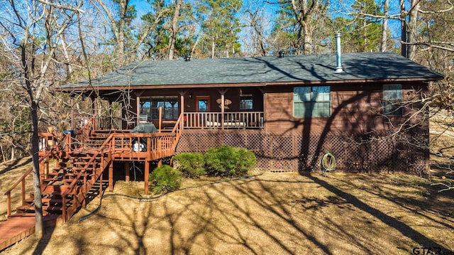 view of front of home with stairway and a wooden deck