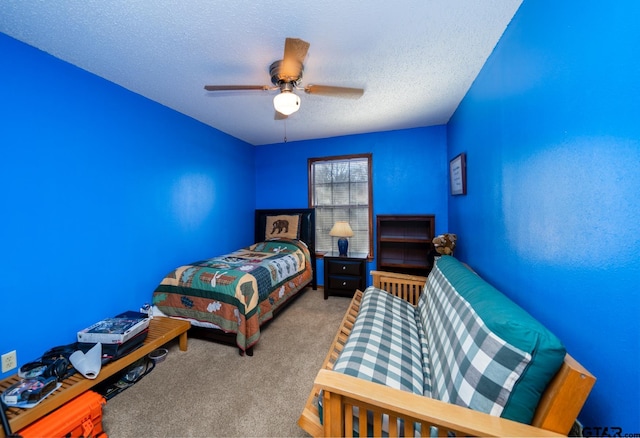 bedroom featuring a textured ceiling, carpet flooring, and a ceiling fan