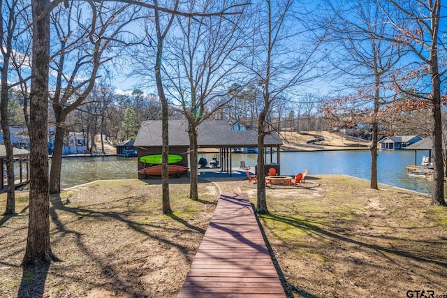 dock area featuring a fire pit and a water view