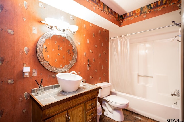 bathroom featuring vanity, shower / bathtub combination with curtain, toilet, and wallpapered walls