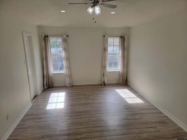 empty room featuring ceiling fan, wood-type flooring, and a textured ceiling