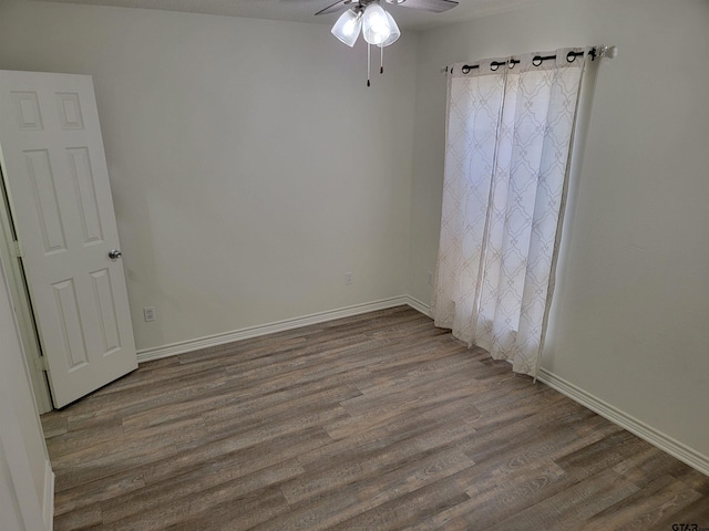 empty room featuring ceiling fan and hardwood / wood-style floors