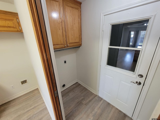 laundry room with cabinets, light wood-type flooring, and electric dryer hookup