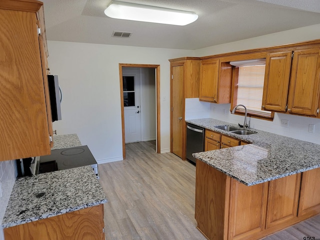 kitchen featuring sink, light hardwood / wood-style flooring, light stone counters, kitchen peninsula, and stainless steel appliances