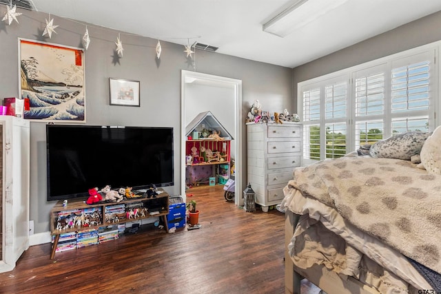 bedroom with dark hardwood / wood-style flooring