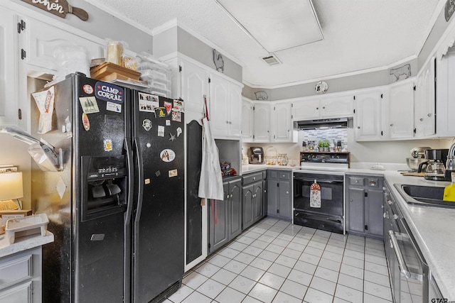 kitchen with black appliances, gray cabinetry, crown molding, range hood, and white cabinets