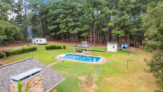 view of pool featuring a lawn