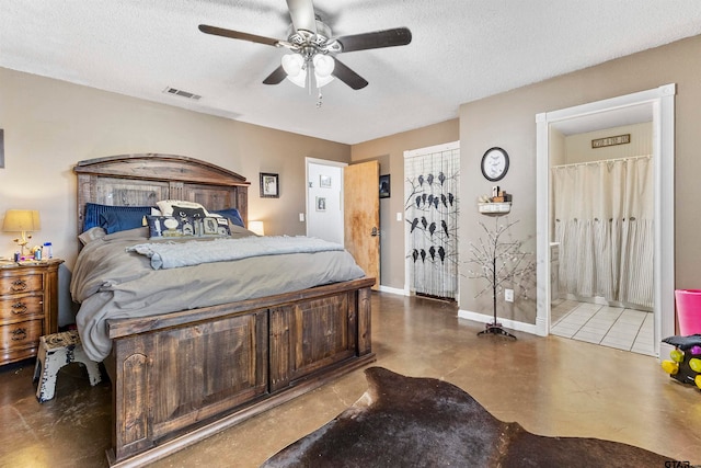 bedroom featuring ensuite bathroom, a textured ceiling, ceiling fan, and concrete floors