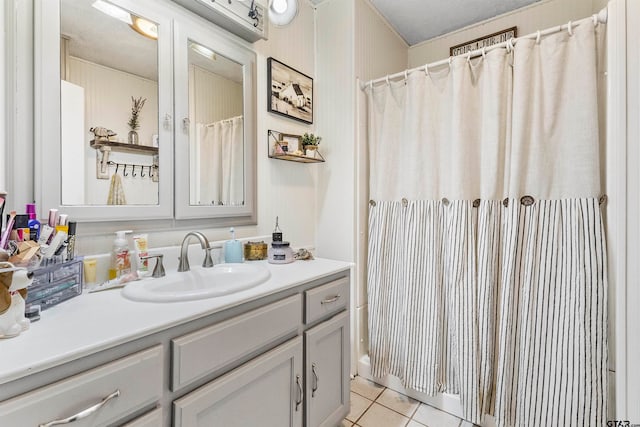 bathroom with vanity, a textured ceiling, and tile patterned floors