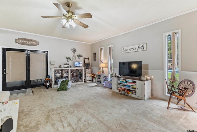 carpeted living room featuring ceiling fan and crown molding