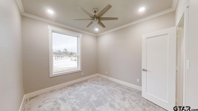 carpeted empty room featuring ceiling fan and ornamental molding